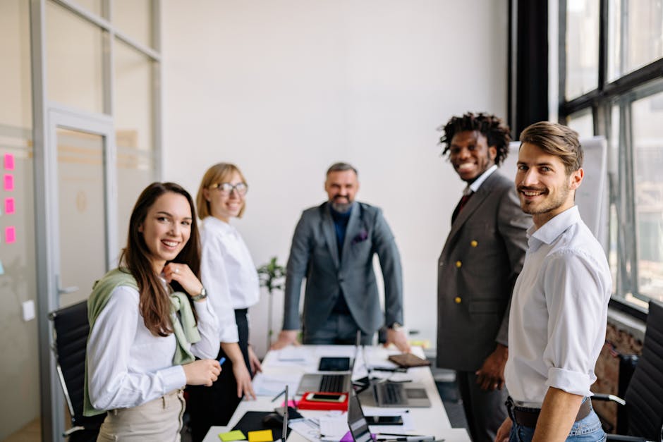 Diverse group of colleagues collaborating in a modern conference room setting.